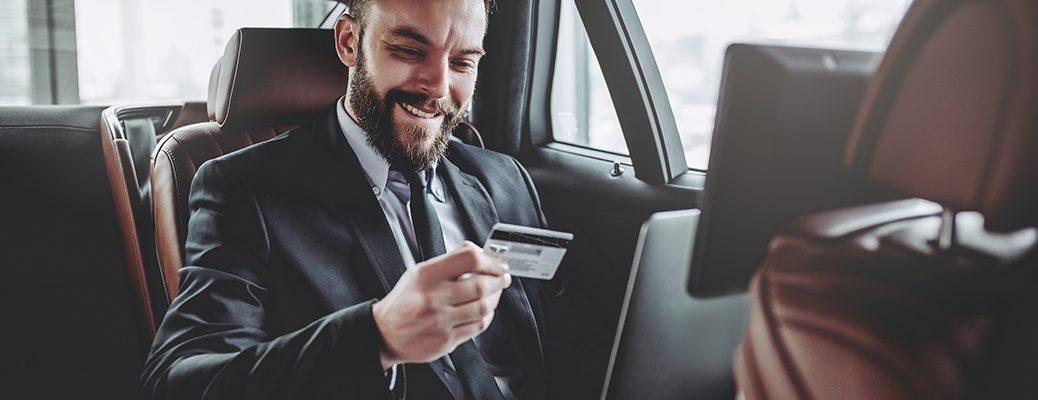 Enterprenuer enjoying using IndusInd Bank Credit Card in a car highlighting business flexibility and convience.