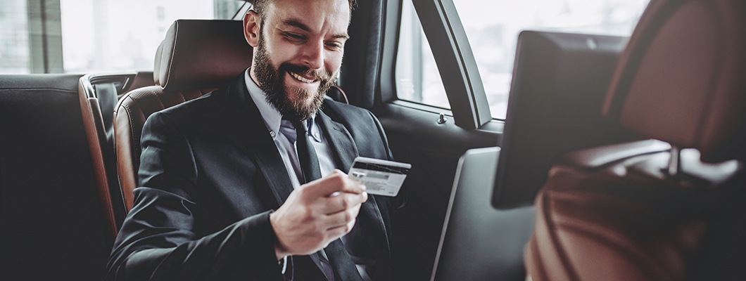 Enterprenuer enjoying using IndusInd Bank Credit Card in a car highlighting business flexibility and convience.