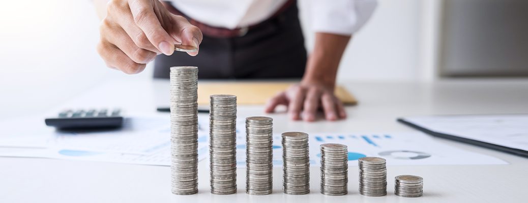 Coin stacks showing rising commitments akin to managing FOIR which evaluates debt to income ratio and is used in loan eligbility.