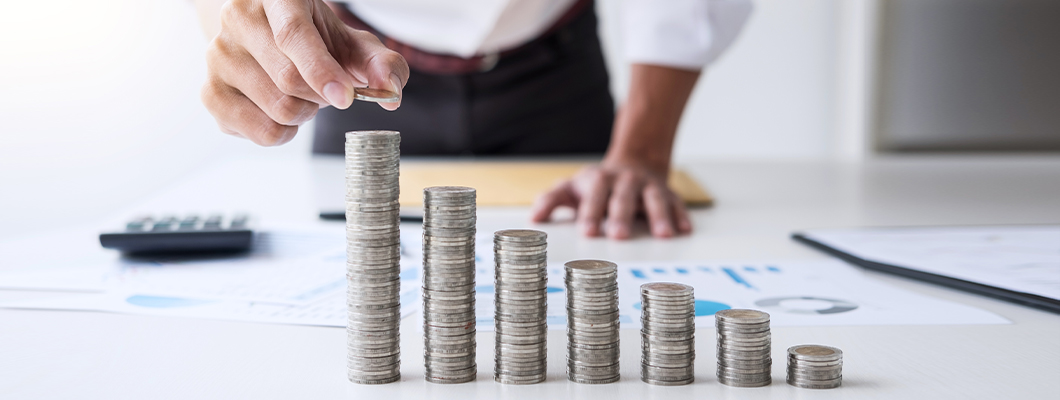 Coin stacks showing rising commitments akin to managing FOIR which evaluates debt to income ratio and is used in loan eligbility.