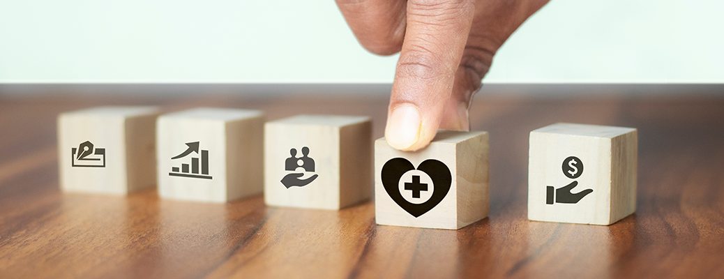 Finger selecting a health icon on blocks, symbolizing IndusInd Bank personal loans as swift solutions in medical emergencies.