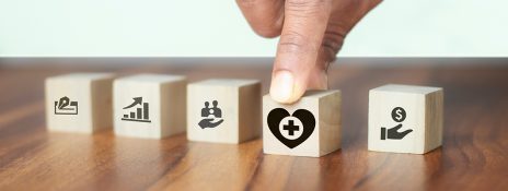 Finger selecting a health icon on blocks, symbolizing IndusInd Bank personal loans as swift solutions in medical emergencies.
