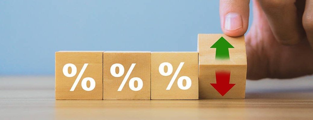 Blocks with % symbols and a hand revealing up/down arrows on one block symbolizing MCLR rate changes and interest rate fluctuations