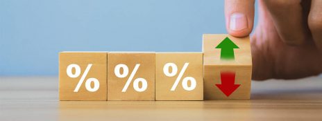 Blocks with % symbols and a hand revealing up/down arrows on one block symbolizing MCLR rate changes and interest rate fluctuations