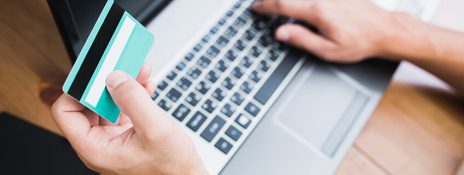 Person using IndusInd Bank credit card on a laptop, highlighting its secure CVV features for safe online transactions and fraud prevention.