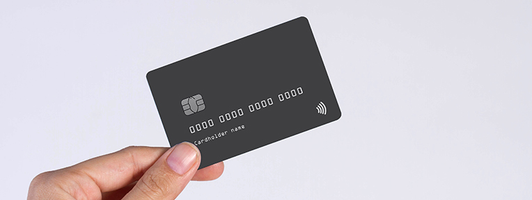 A hand holds a sleek card. Discover the Best Credit Card options for 2025 from IndusInd Bank to elevate your spending today!