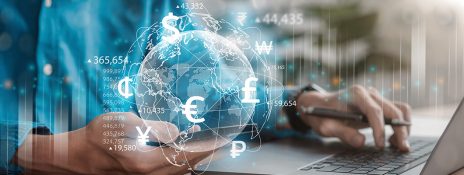 Person using a laptop with digital globe and currency symbols, comparing Forex cards and cash. Unlock seamless international travel with an IndusInd Bank forex card