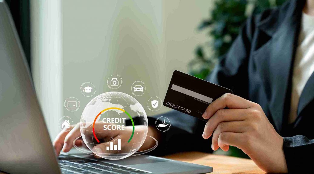 Person with IndusInd Bank credit card and laptop, highlighting how secured cards can help improve credit scores and achieve financial goals.