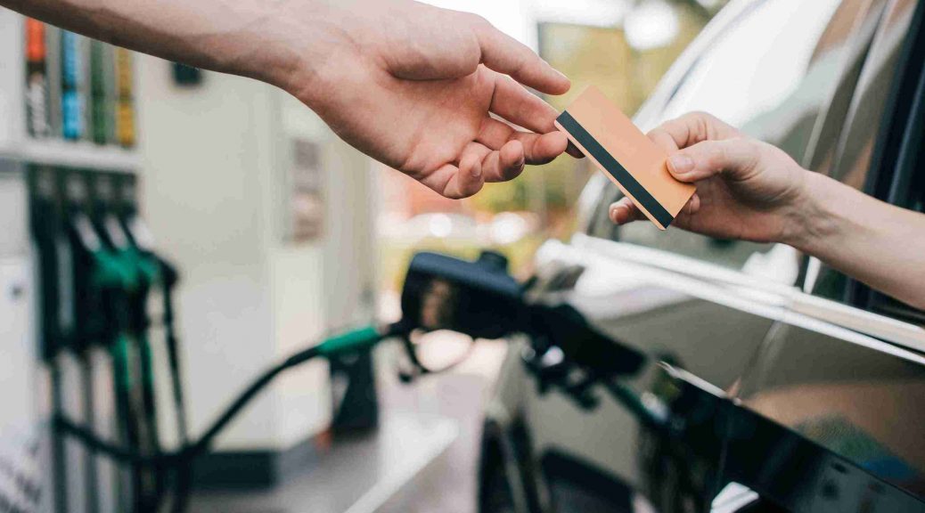 Person enjoying fuel surcharge waiver by getting their car refuled with IndusInd Bank Credit Card.