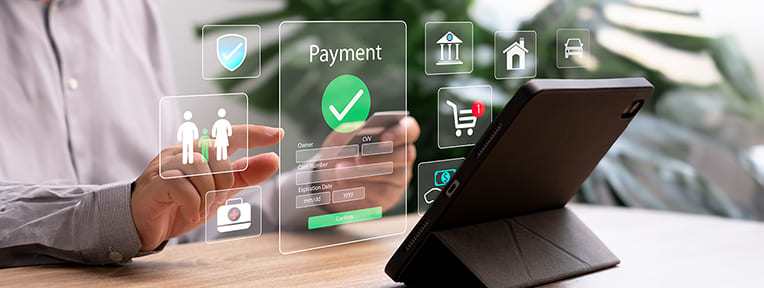 Person managing online payment for utility bills payments over a tablet with convenience and easy management through IndusInd Bank Credit Card.