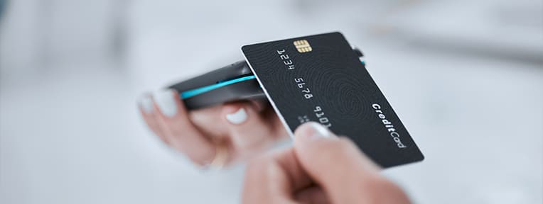 Credit Card being used in a card reader, representing a transaction and showcasing how do credit cards work.