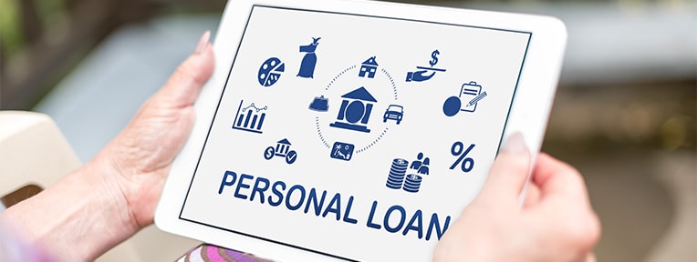 Person applying for Personal Loan with PAN Card using a tablet seamlessly with IndusInd Bank.