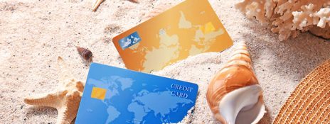 Two credit cards on sand, illustrating revolving credit. Apply to IndusInd Bank Credit Card for Flexible Spending,