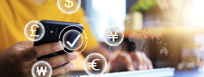 Person using IndusInd Bank's International Money Transfer Service on a smartphone.