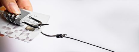 Credit card secured with a lock and a hooked wire signifying IndusInd Bank Credit Card's protection against fraud and added security.